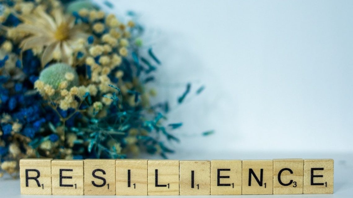 a scrabble type block spelling the word resilince