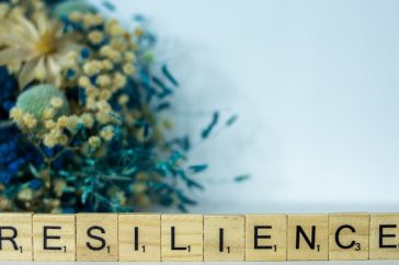 a scrabble type block spelling the word resilince